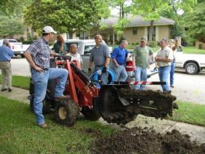 the Haltom City Irrigatin team take a break from trenching a new sprinkler line