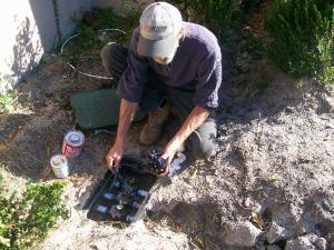 a valve box being installed by a sprinkler repair team member