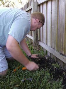 a technician replaces a pop up sprinkler head